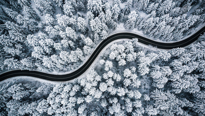 Lenvi banner image of a winding road through snow and trees