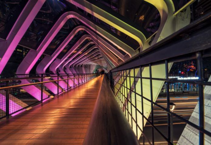 Lenvi image of a bridge with purple lighting and metal railings