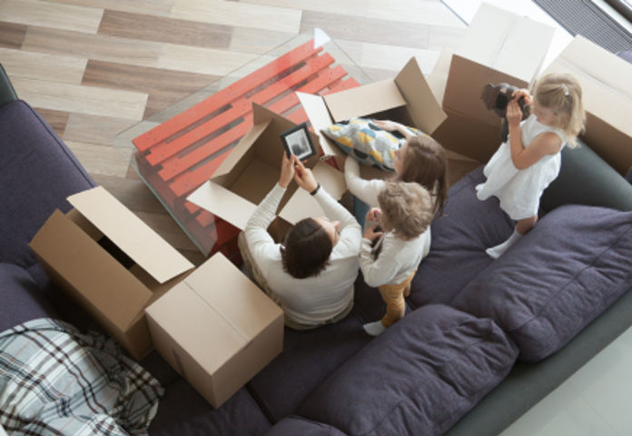 Family surrounded by moving boxes, symbolising homeowners in the UK mortgage lending market roundup - Lenvi Insights