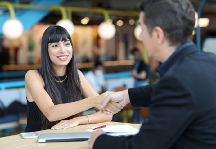 Two business professionals shaking hands, symbolising a FinTech partnership fueling innovation and lending solutions - Lenvi Insights