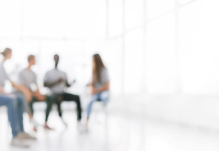 Blurred figures in a group, representing proactive credit risk management and customer financial support