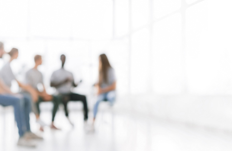 Blurred figures in a group, representing proactive credit risk management and customer financial support