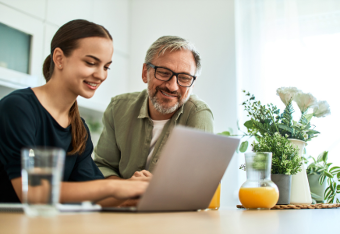 Gen Z woman and parent looking at a laptop, symbolising the 'Bank of Mum and Dad' for UK borrowers.