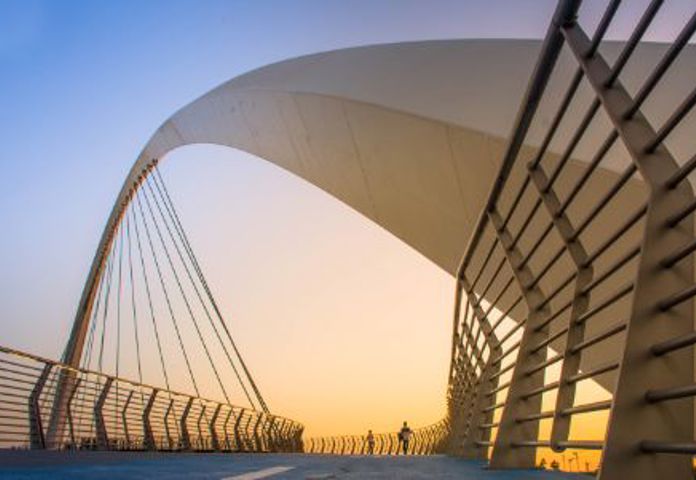 Modern arched bridge at sunset, symbolising fighting fraud with Lenvi Riskfactor's focus lists