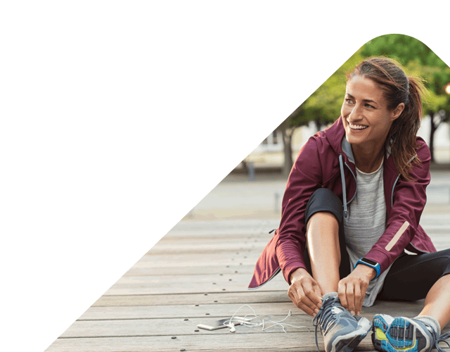 Lenvi image of a woman in running clothing tying her shoe lace