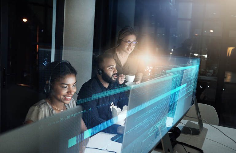 People working at computer workstations with digital data and analytics overlays