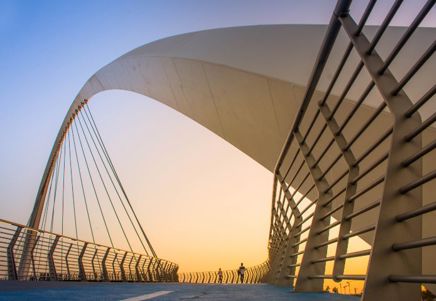 Lenvi image of a bridge at sunrise with metal railings