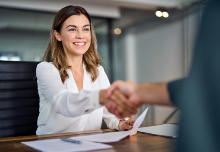 Smiling professional woman shaking hands, symbolising Lenvi’s high-performance Fitch Servicer Rating achievement