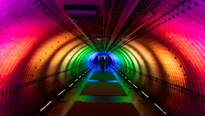 Tunnel brightly lit with multi-coloured lighting