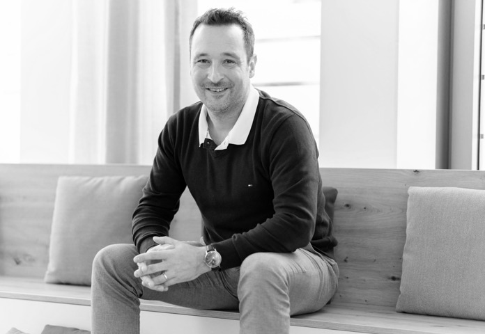 DACH region Business Director Falko Junge Sitting On Bench