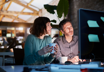 Lenvi QA professionals collaborating on a computer, demonstrating their quality assurance approach